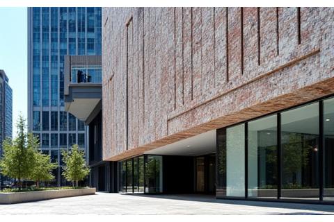 Modern building facade with intricate ceramic tile installation, showing architectural integration.